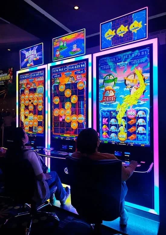 Four colorful penguin characters in green, yellow, red, and pink from gameplay