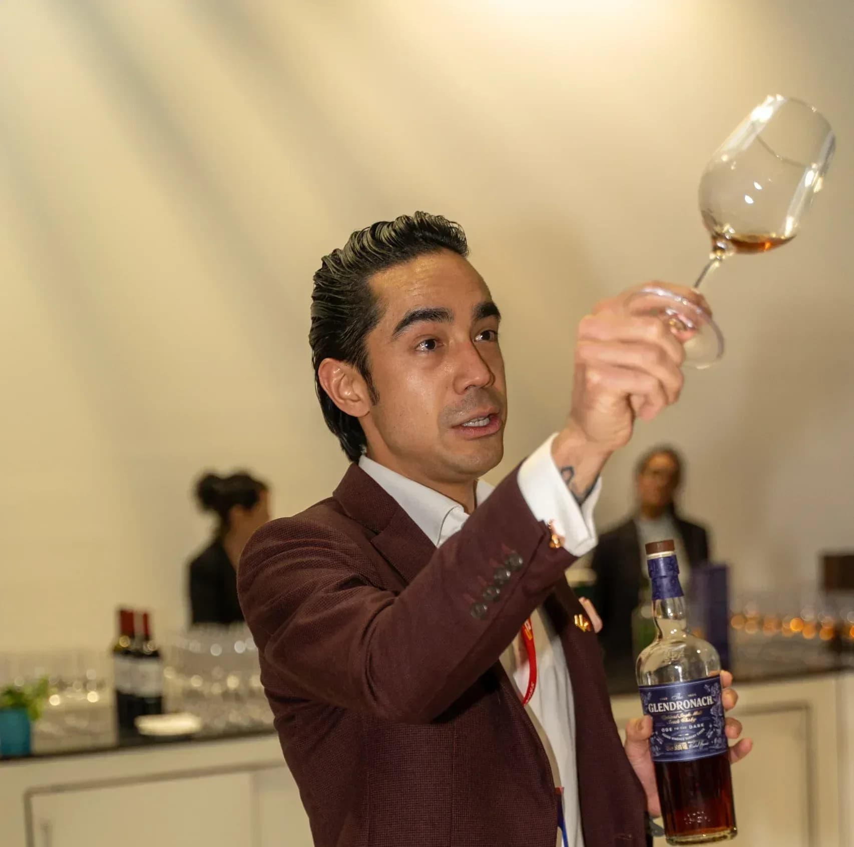 Attendee enjoys whisky tasting at SOFTSWISS networking event highlighting transparent pricing structures